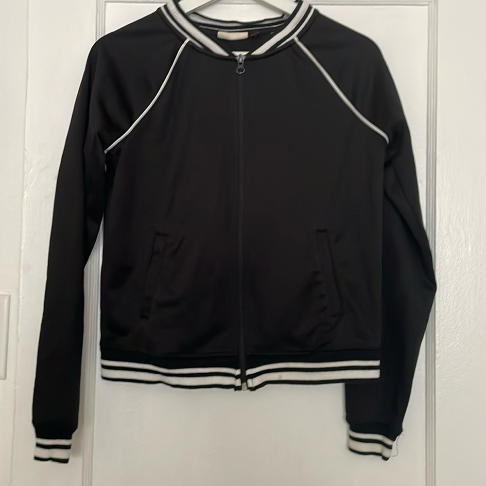 Black jacket white bands on neckline and  sleeves